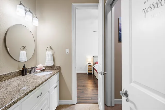 a bedroom with a bed a table and chair