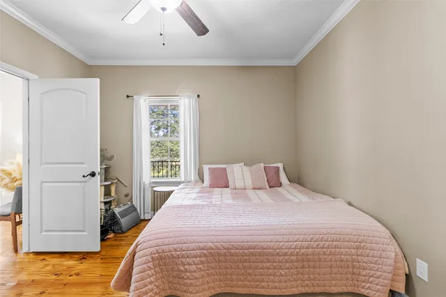 a bedroom with a bed and a computer on the desk