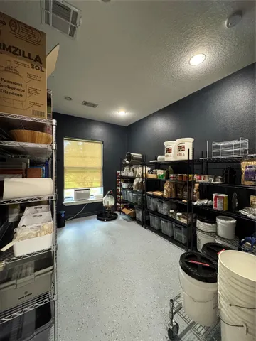 a garage with furniture and a flat screen tv