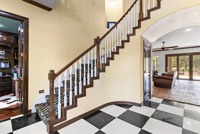a view of staircase with wooden floor and a rug