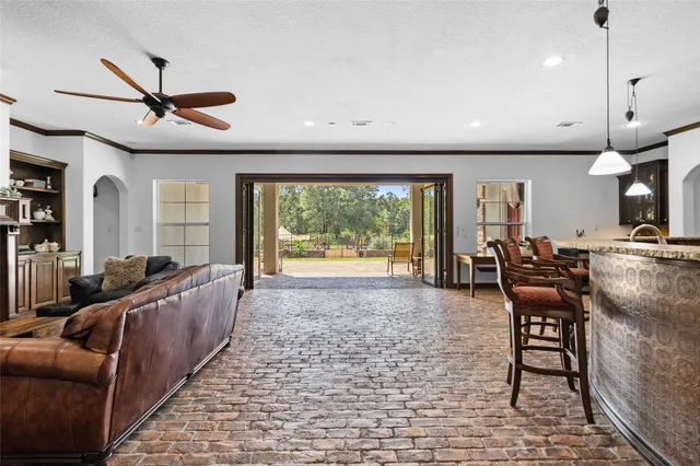 a living room with furniture and a floor to ceiling window