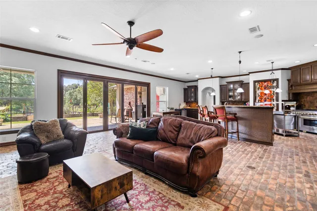 a living room with furniture ceiling fan and a rug