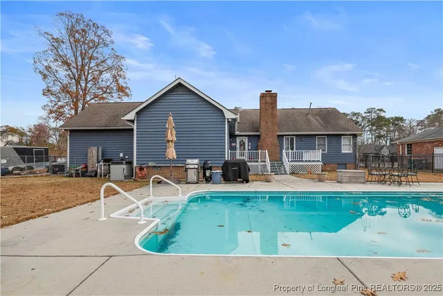 a front view of a house with swimming pool having outdoor seating