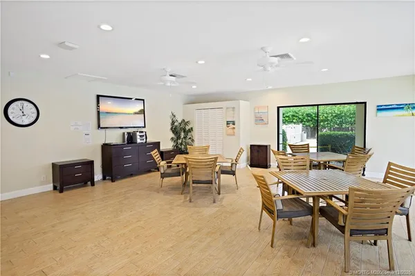 a living room with furniture a window and a flat screen tv