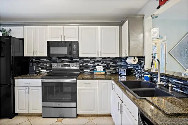 a kitchen with a sink stove and microwave
