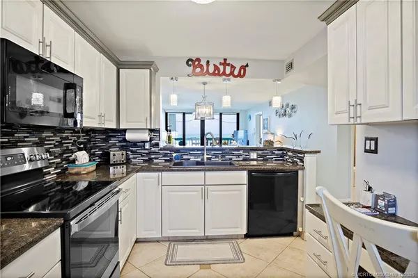 a kitchen with stainless steel appliances a sink stove and cabinets