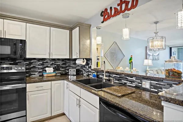 a kitchen with a sink stove and microwave