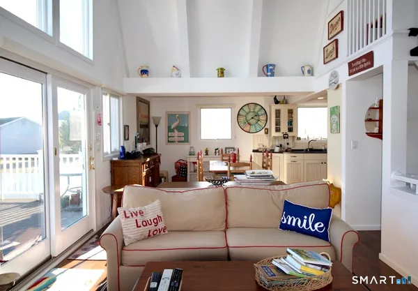 a living room with furniture and a clock