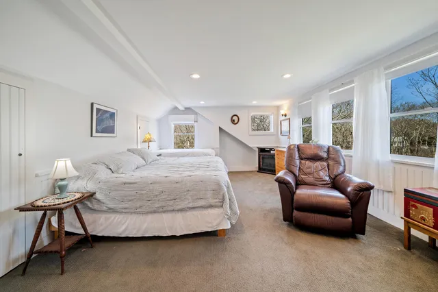 a bedroom with double bed and a lamp