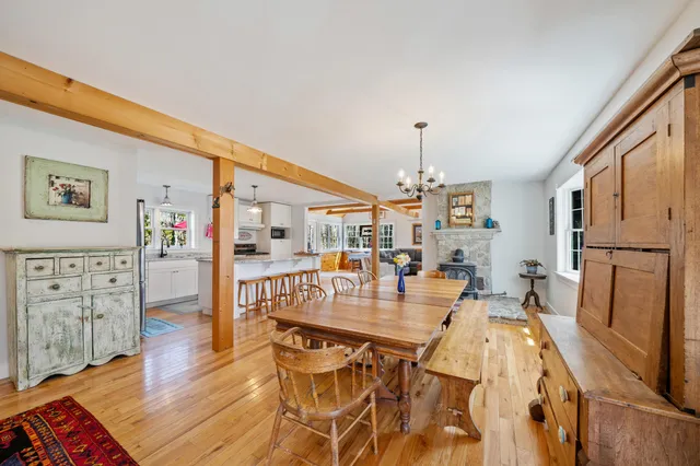 a kitchen with stainless steel appliances kitchen island wooden floors and white cabinets