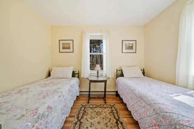 a picture of floor with a white wall and a painting