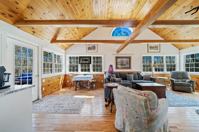 a bedroom with two beds and a wooden floor