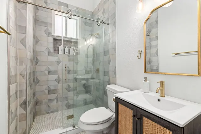 a bathroom with a sink toilet and shower