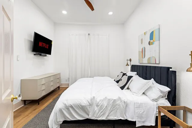 a bedroom with a bed and a flat screen tv