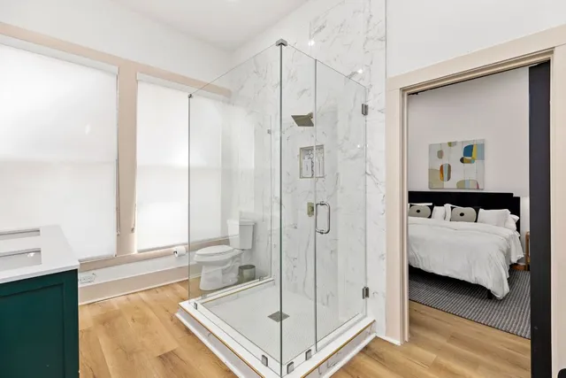 a en suite bathroom with a tub shower and window