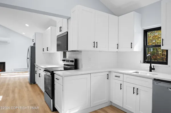 a kitchen with a sink cabinets and stainless steel appliances
