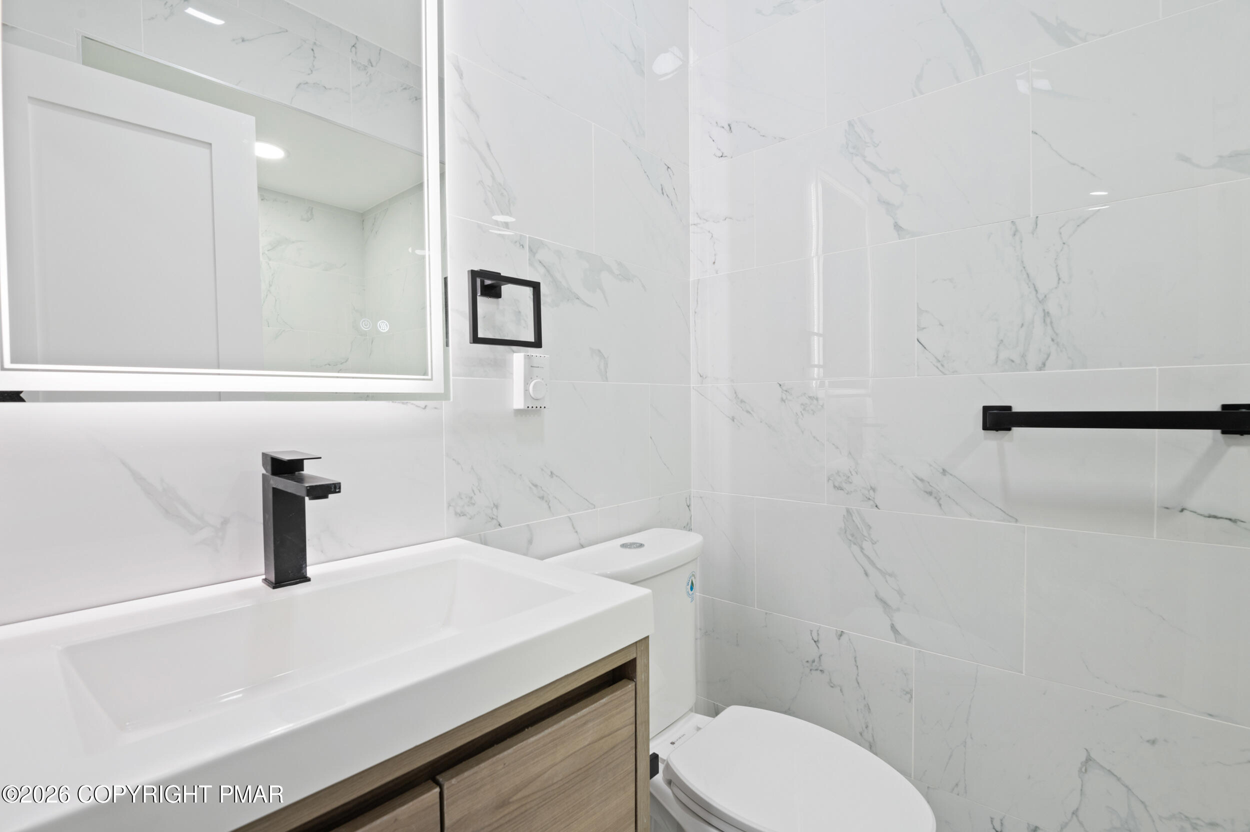 120 Twin Rivers Road, Unit B Lackawaxen, PA 18435 - Photo 21 of 29 a bathroom with a sink a toilet and mirror