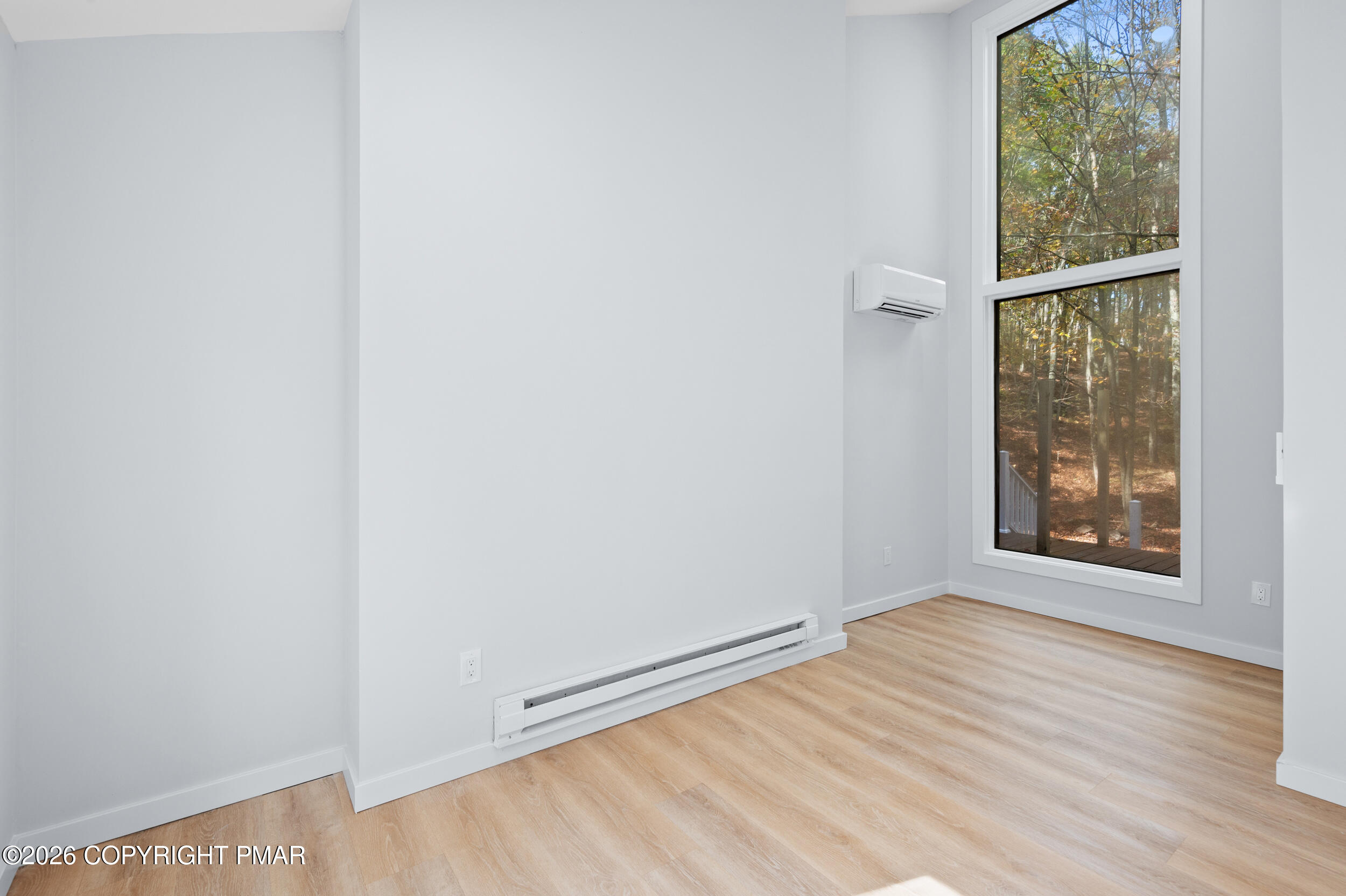 120 Twin Rivers Road, Unit B Lackawaxen, PA 18435 - Photo 24 of 29 an empty room with wooden floor and windows