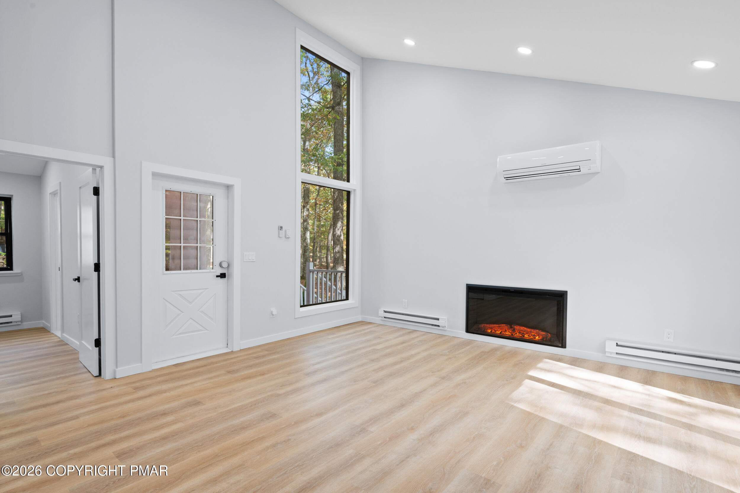 120 Twin Rivers Road, Unit B Lackawaxen, PA 18435 - Photo 8 of 29 a view of an empty room with window and fire place