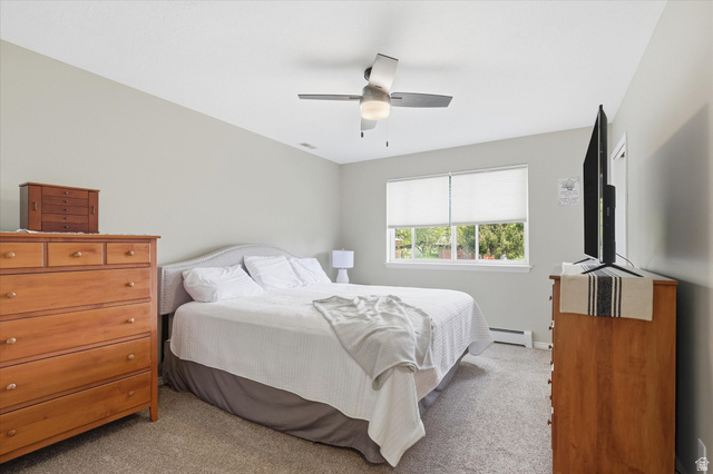 45 West 100 South Mendon, UT 84325 - Photo 22 of 64 Bedroom featuring light colored carpet, a ceiling fan, and a baseboard heating unit