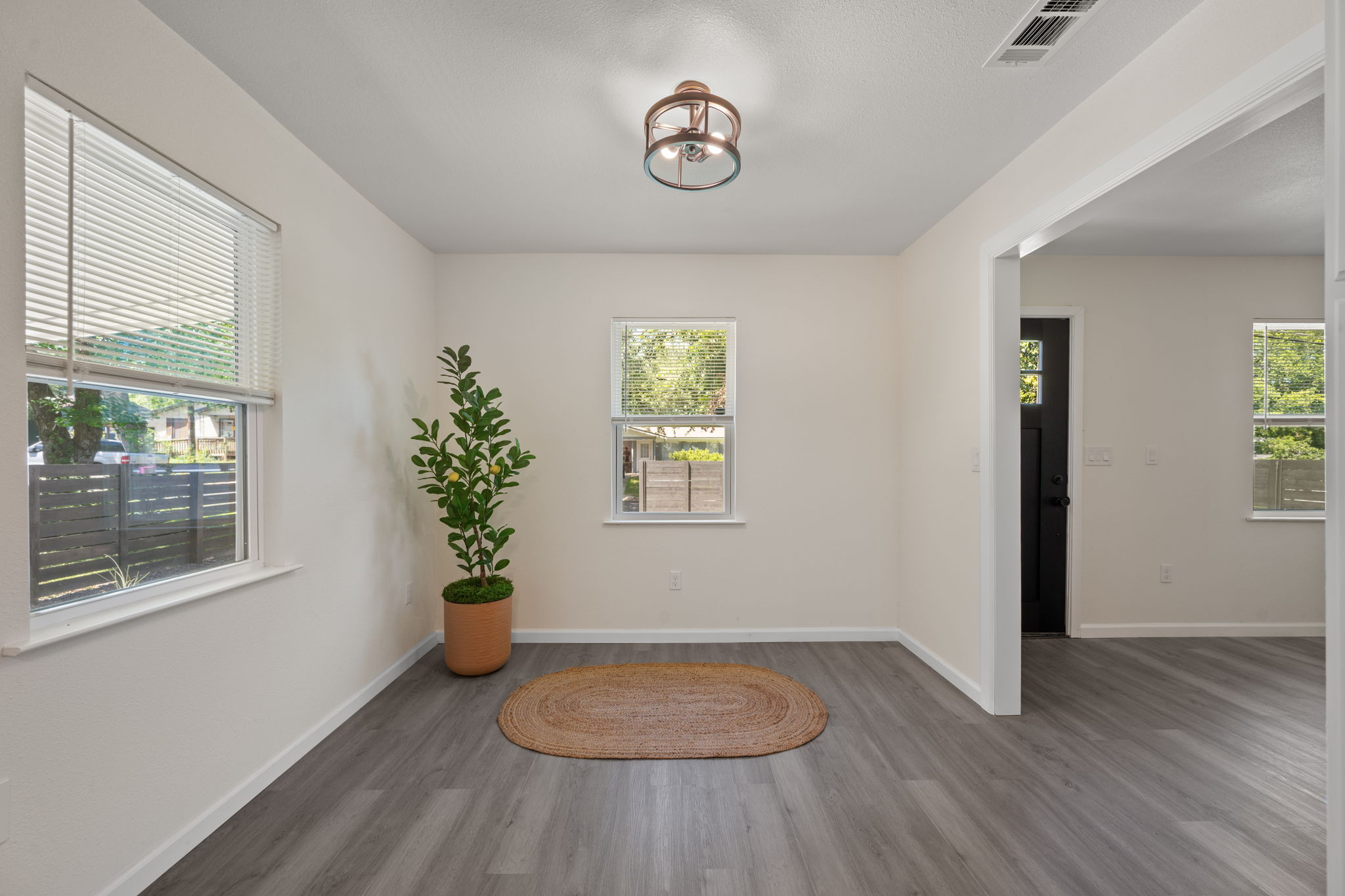 4711 Bandera Road Austin, TX 78721 - Photo 6 of 22 a view of empty room with window and wooden floor