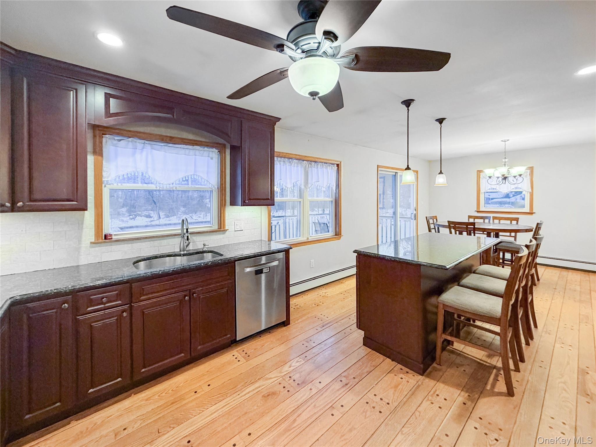 25 East Mountain Road South Cold Spring, NY 10516 - Photo 12 of 48 a kitchen with stainless steel appliances granite countertop wooden floors and wooden cabinets