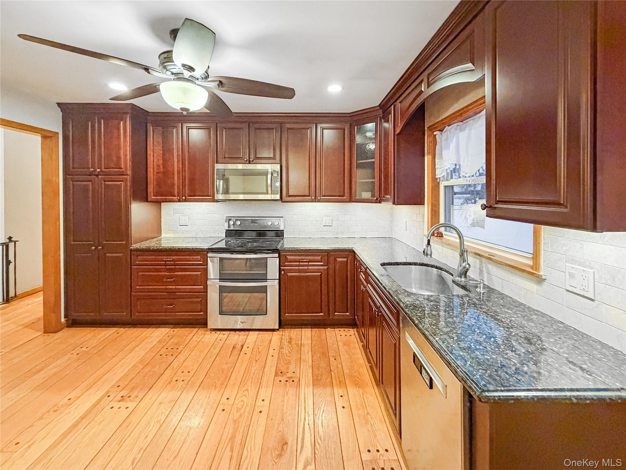 25 East Mountain Road South Cold Spring, NY 10516 - Photo 13 of 48 a kitchen with stainless steel appliances granite countertop a sink and cabinets