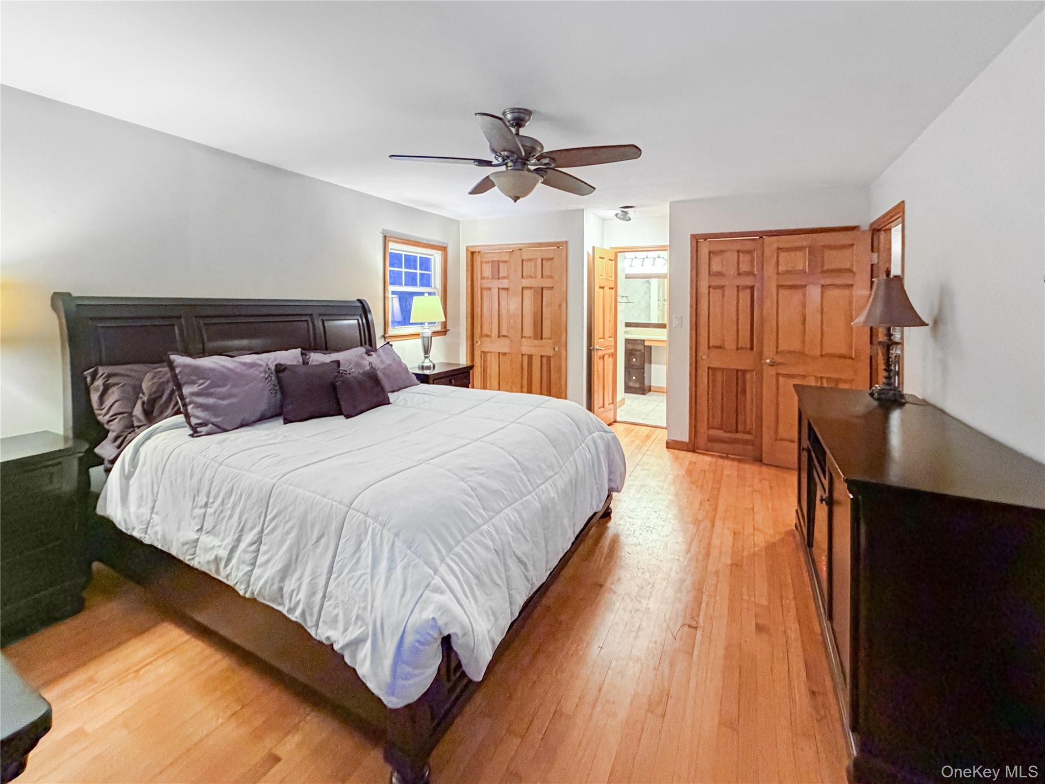 25 East Mountain Road South Cold Spring, NY 10516 - Photo 16 of 48 a spacious bedroom with a bed and wooden floor