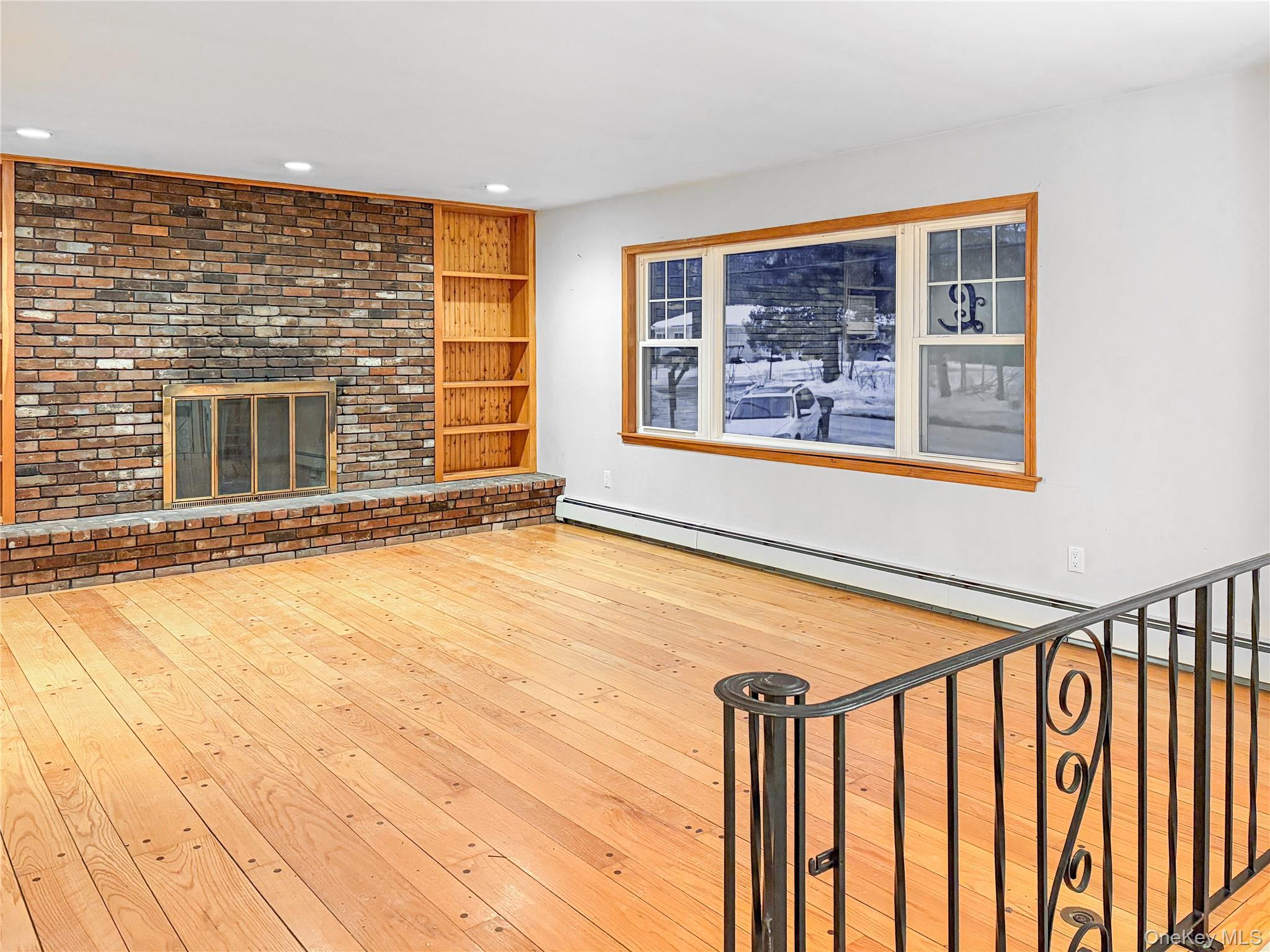 25 East Mountain Road South Cold Spring, NY 10516 - Photo 4 of 48 a view of an empty room with a fireplace and a window