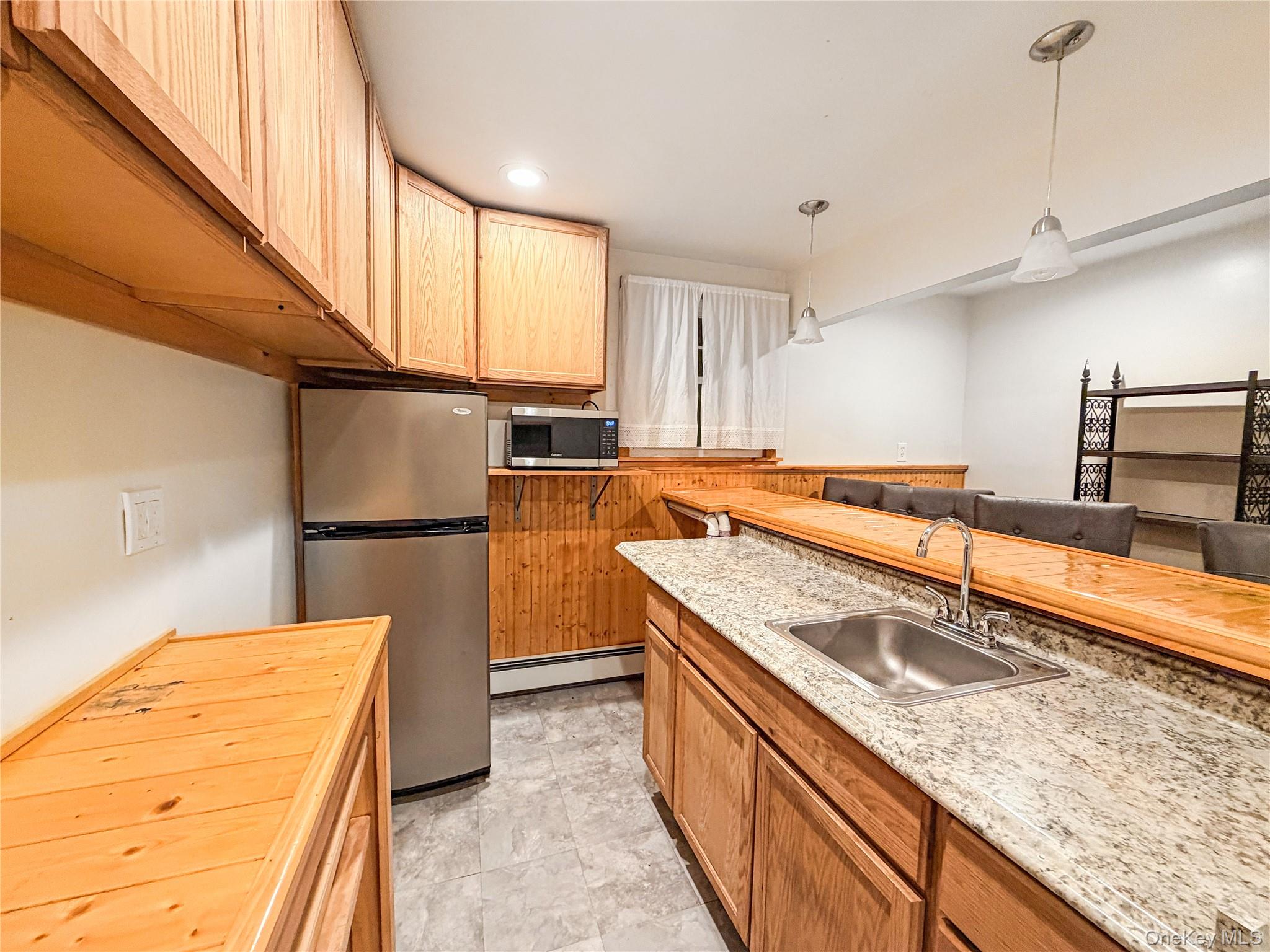 25 East Mountain Road South Cold Spring, NY 10516 - Photo 41 of 48 a kitchen with stainless steel appliances granite countertop a sink a stove and a refrigerator