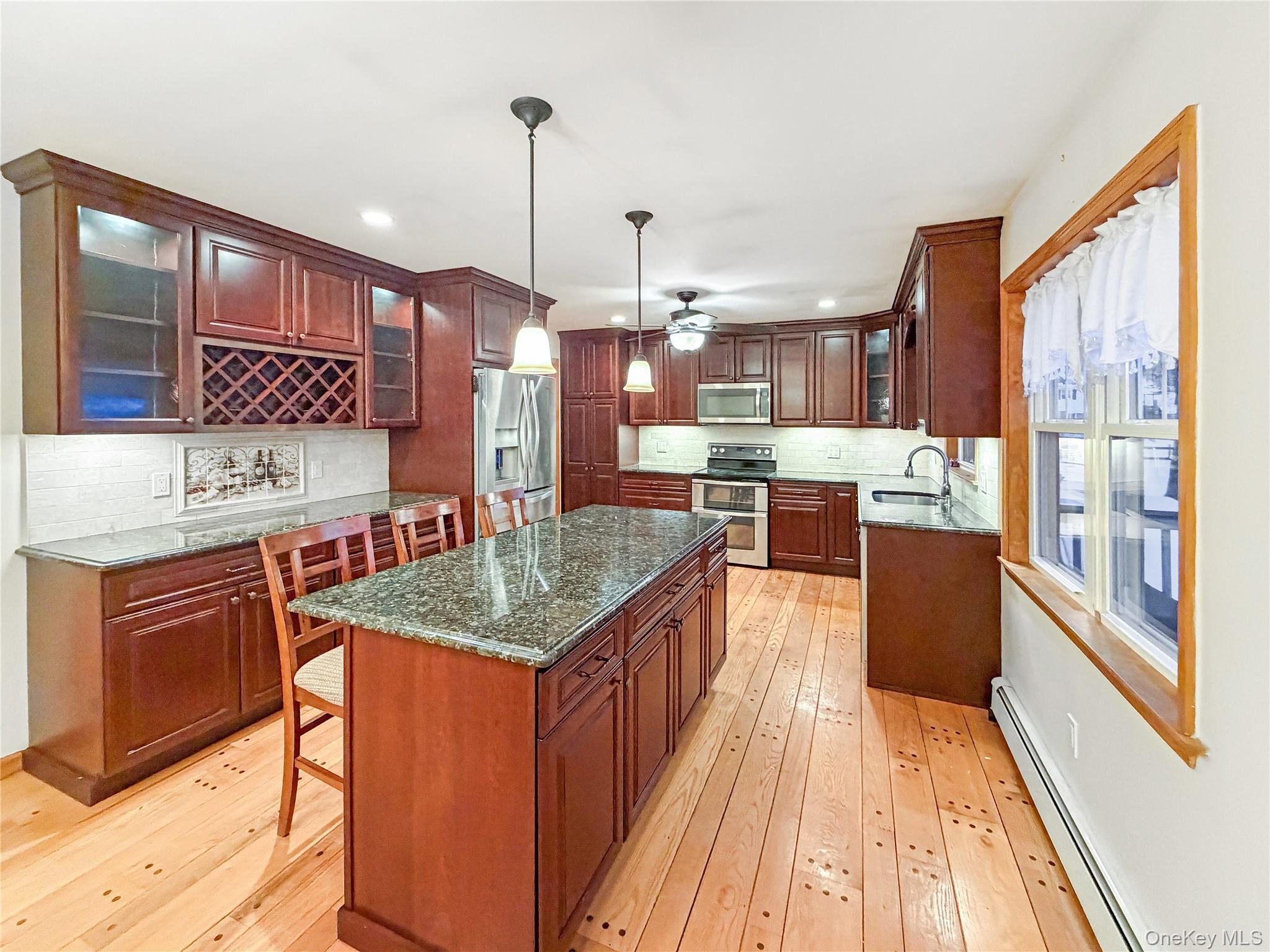 25 East Mountain Road South Cold Spring, NY 10516 - Photo 9 of 48 a kitchen with stainless steel appliances granite countertop sink stove top oven and cabinets