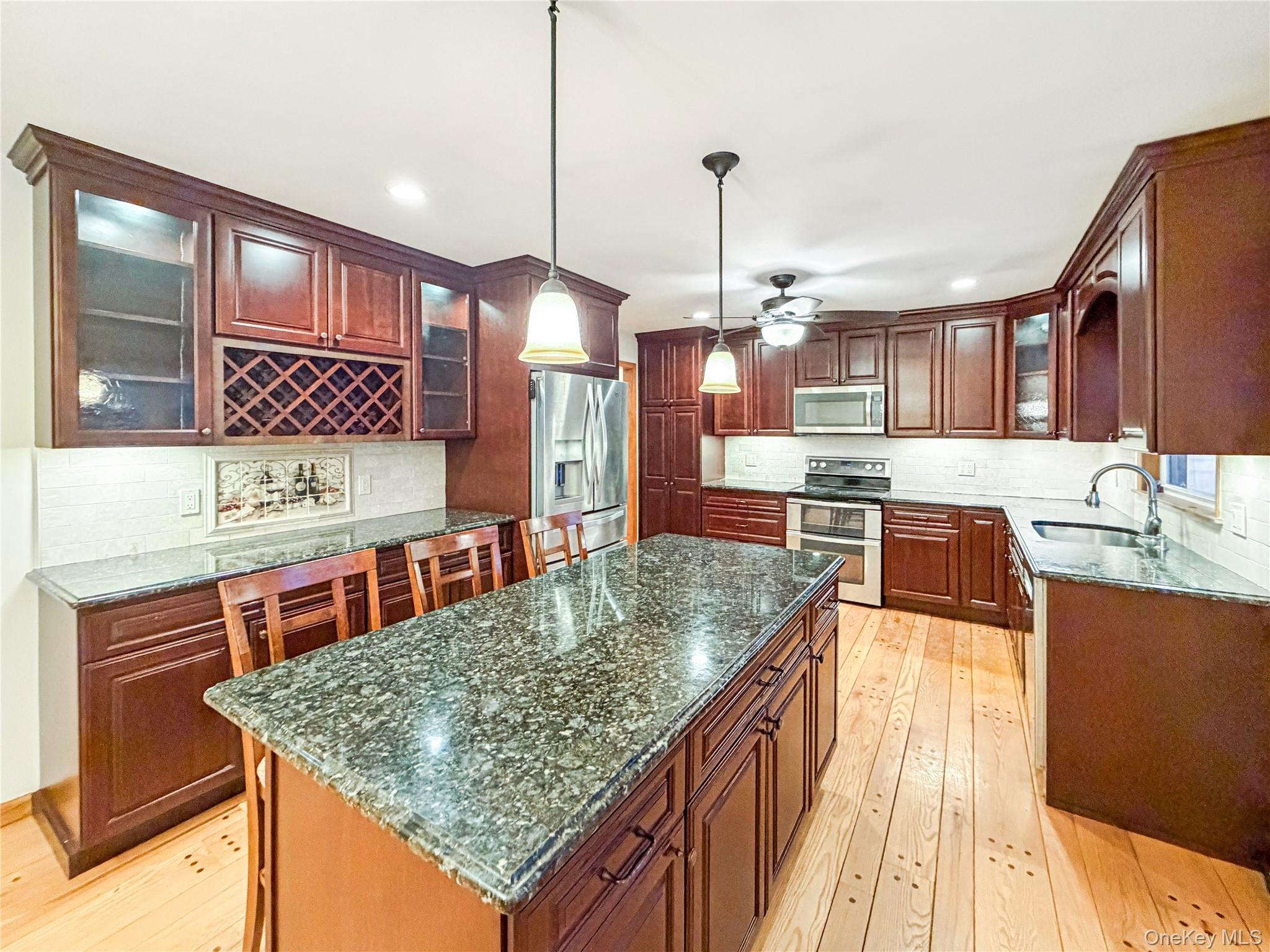 25 East Mountain Road South Cold Spring, NY 10516 - Photo 10 of 48 a kitchen with stainless steel appliances granite countertop a sink a counter space and cabinets