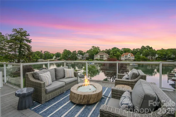 a view of a patio with couches chairs and a potted plant