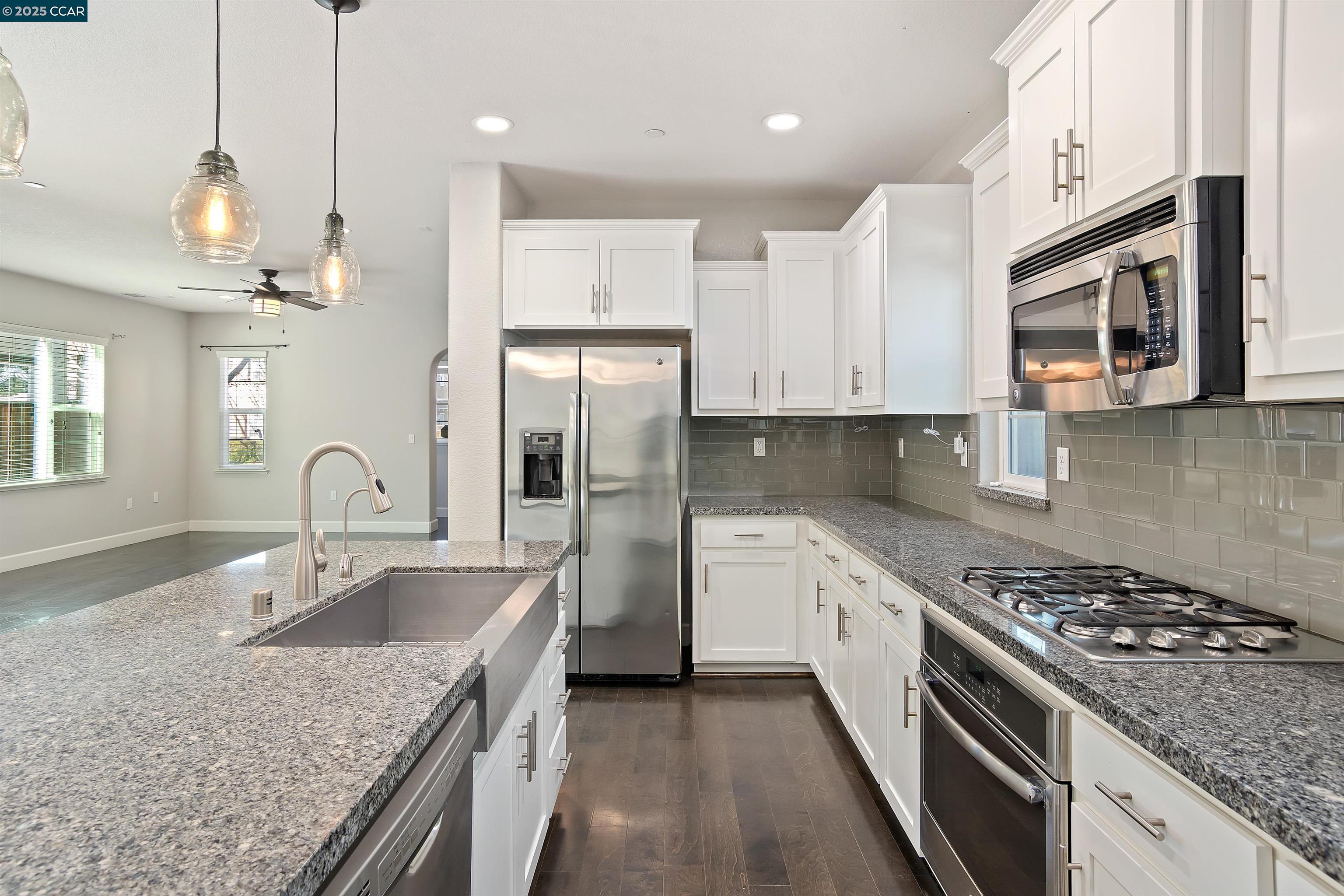 4969 Ivy Leaf Springs Road San Ramon, CA 94582 - Photo 14 of 34 a kitchen with stainless steel appliances granite countertop a sink stove and refrigerator