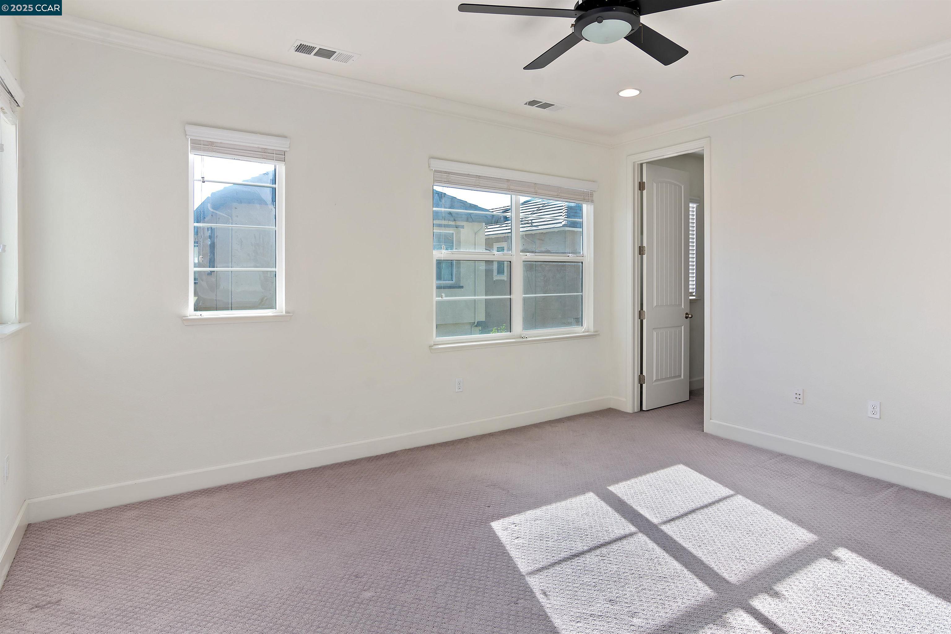 4969 Ivy Leaf Springs Road San Ramon, CA 94582 - Photo 18 of 34 an empty room with windows and ceiling fan