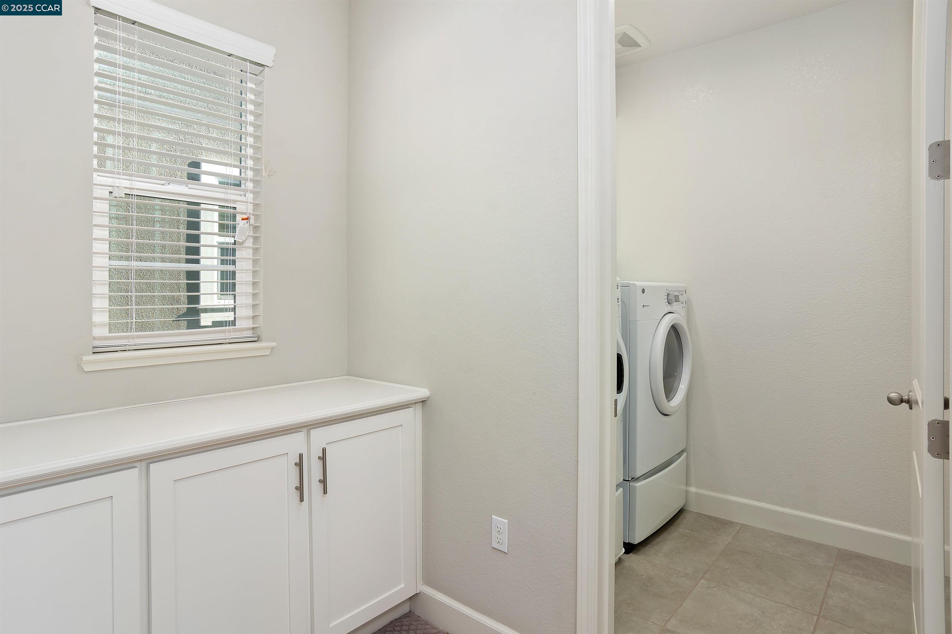 4969 Ivy Leaf Springs Road San Ramon, CA 94582 - Photo 30 of 34 a view of a storage and utility room with washer and dryer