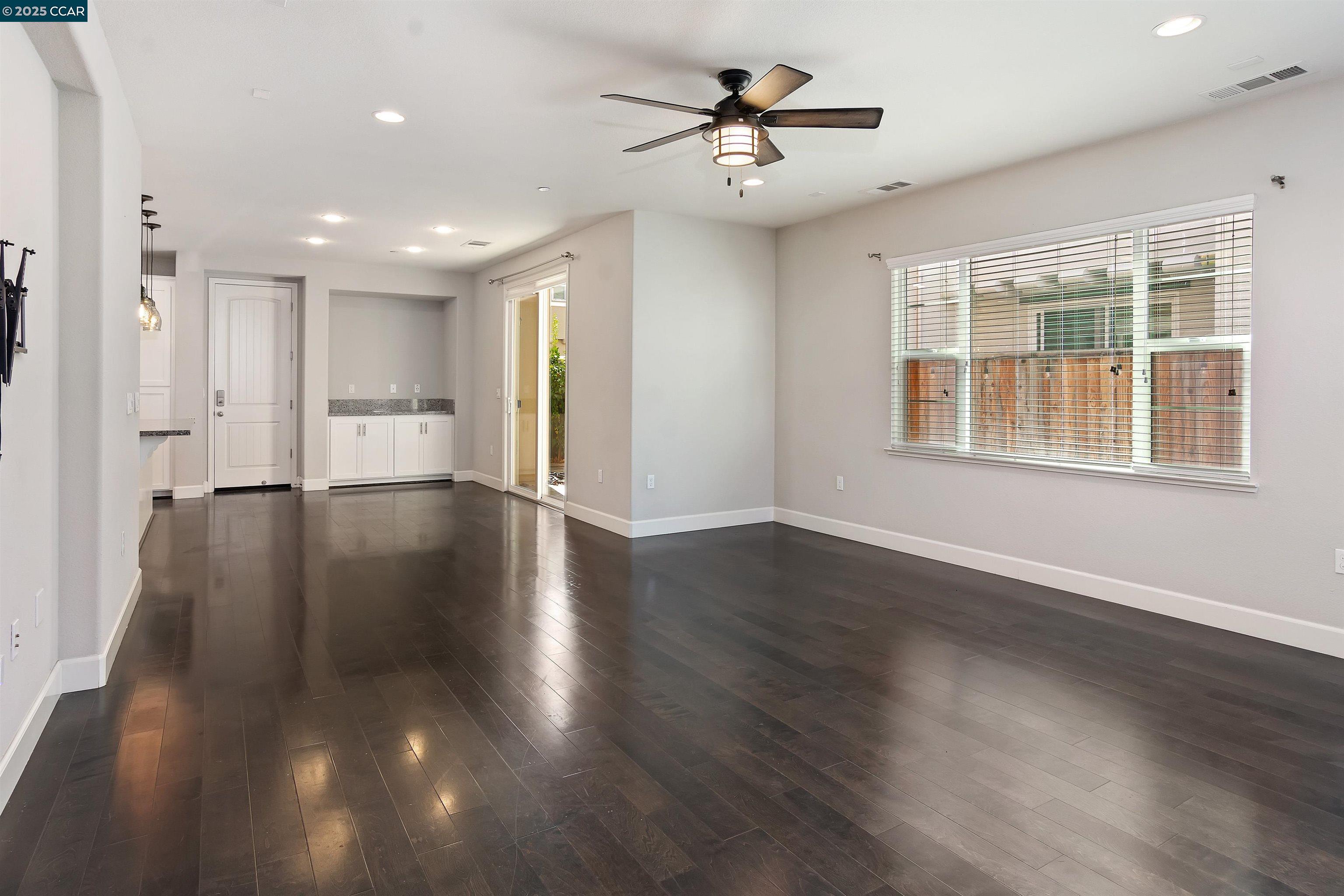 4969 Ivy Leaf Springs Road San Ramon, CA 94582 - Photo 7 of 34 a view of an empty room with a window and wooden floor