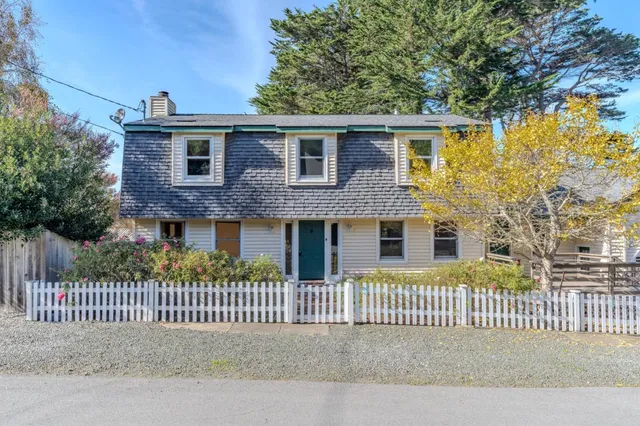 a front view of a house with a fence