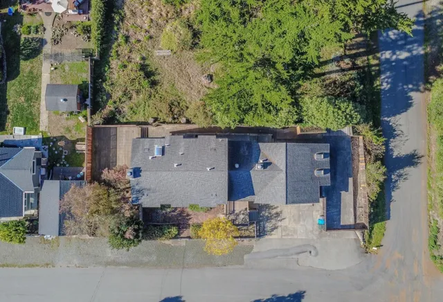 an aerial view of a house with a yard and sitting area