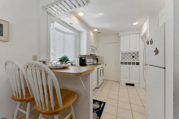 a kitchen with kitchen island a appliances a sink a counter top space and cabinets