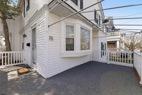 a view of a house with porch and furniture