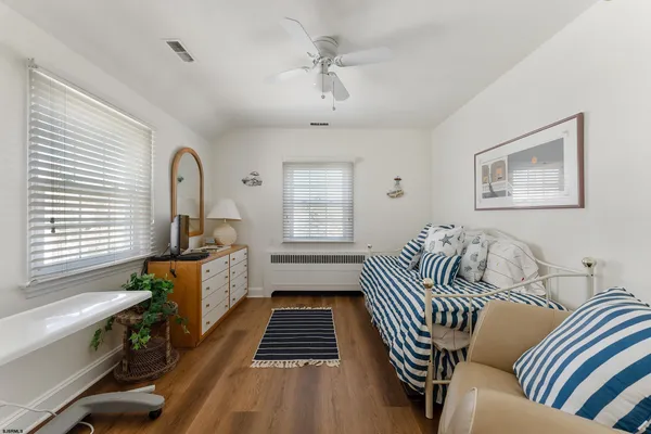a bedroom with furniture and a window