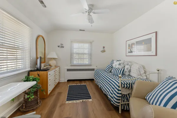 a bedroom with furniture and a window