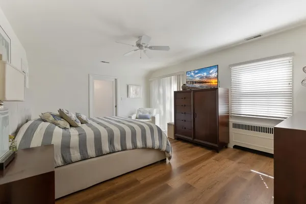 a bedroom with a bed and dresser