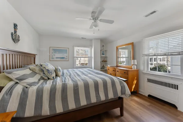 a bedroom with a large bed and a window