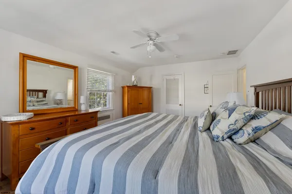 a bedroom with a large bed and a window