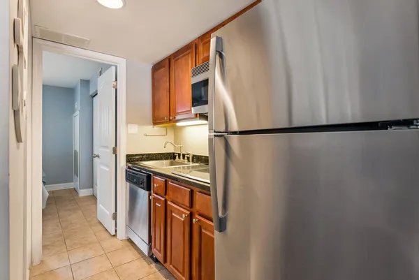 a kitchen with stainless steel appliances granite countertop a sink stove and cabinets