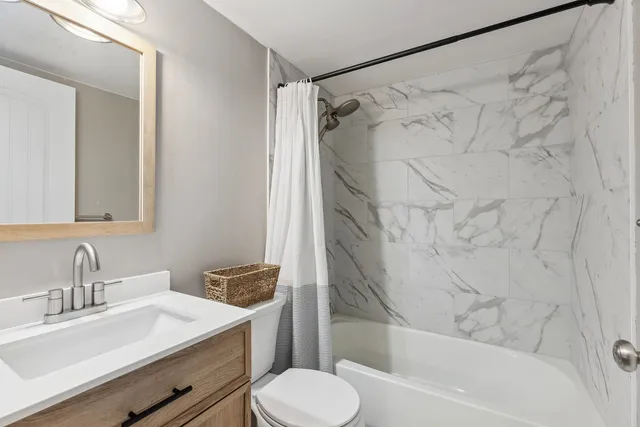 a bedroom with a bed a mirror and a window