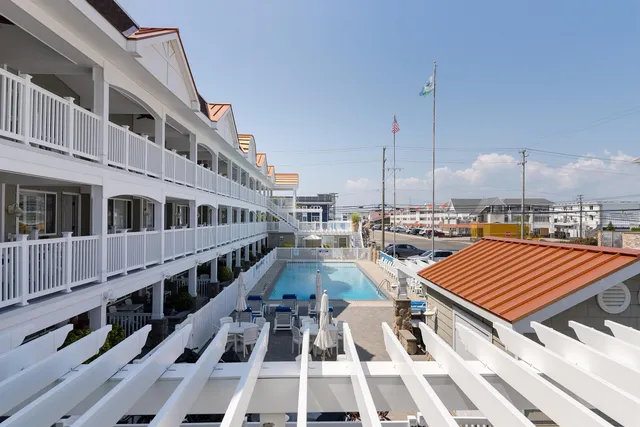 a view of building with swimming pool and sitting space