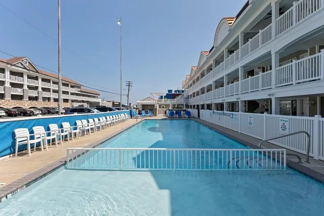 a kitchen with a sink a counter and chairs